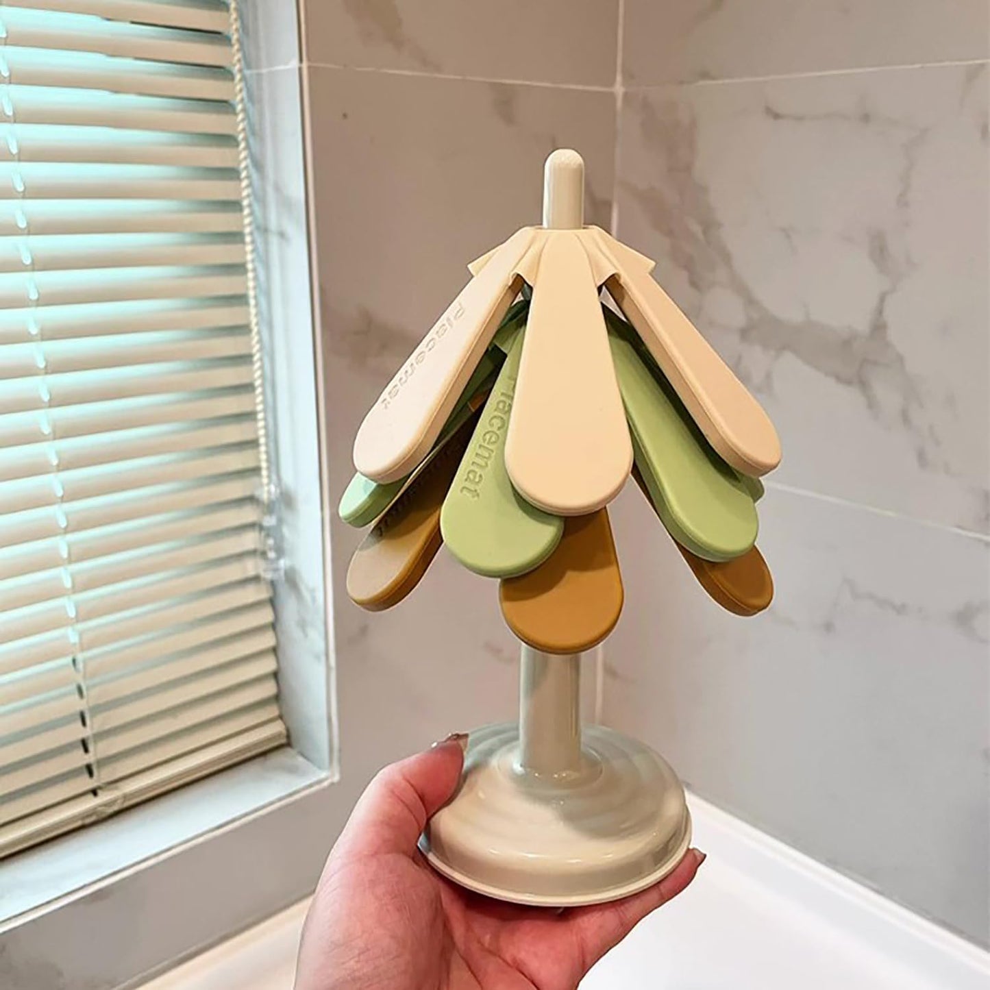 Tree-shaped silicone trivet set with stand in a modern kitchen setting