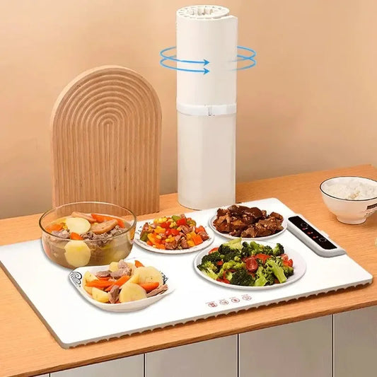 Tabletop food warmer with plates of food on a wooden table
