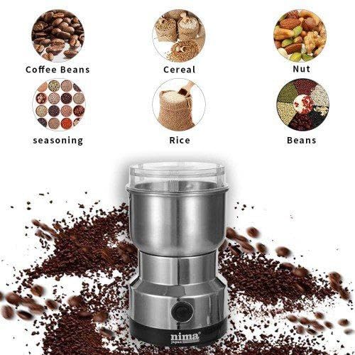 Nima coffee grinder with coffee beans, cereal, nut, rice, and seasoning around it on a white background.
