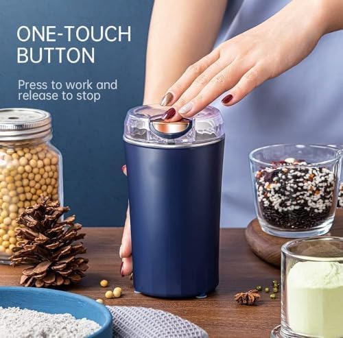 Navy blue spice grinder with one-touch button on a wooden table with ingredients and containers.