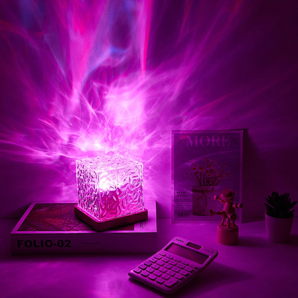 Colorful light display on a desk with a book and calculator in the background