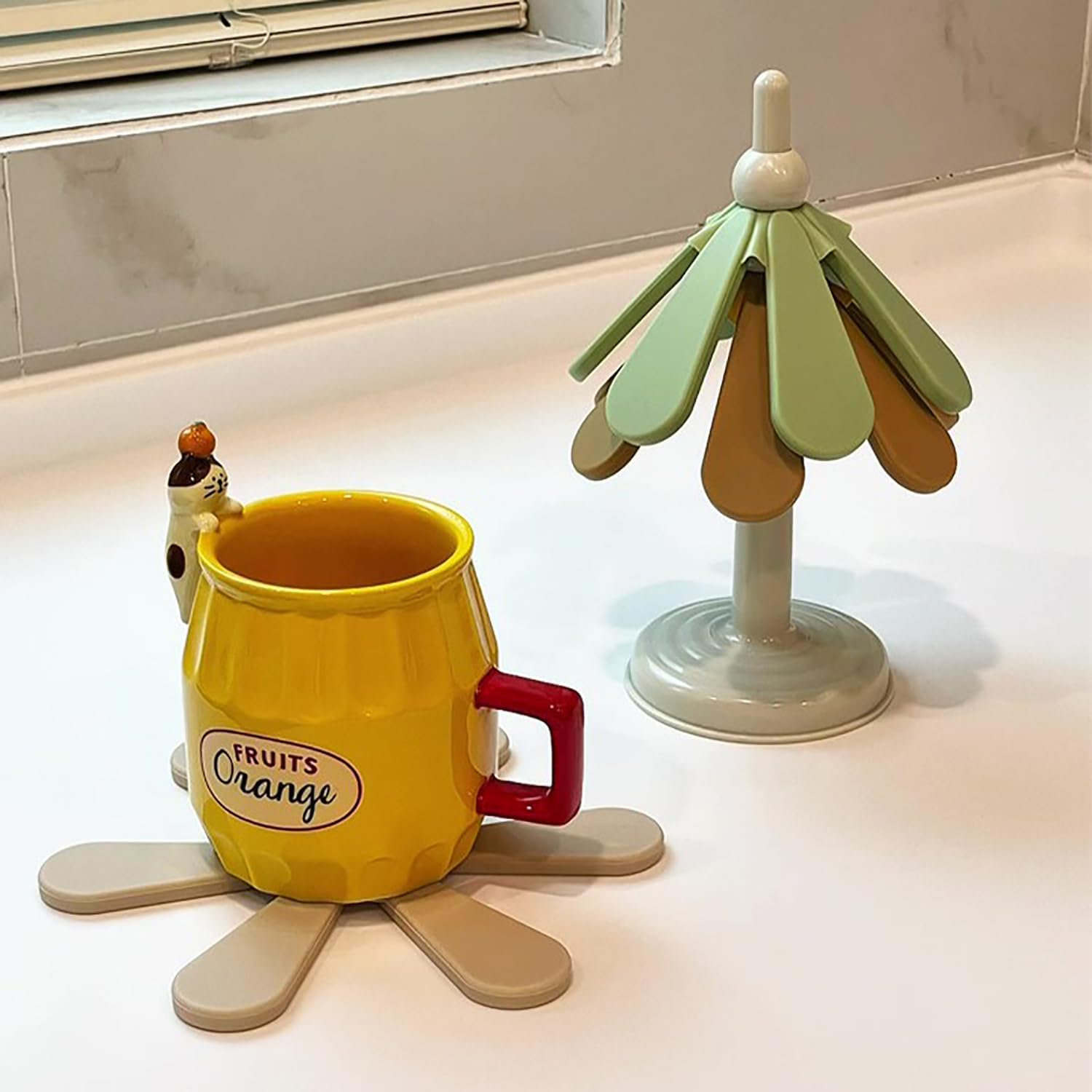 Tree-shaped silicone trivet set with stand in a modern kitchen setting

