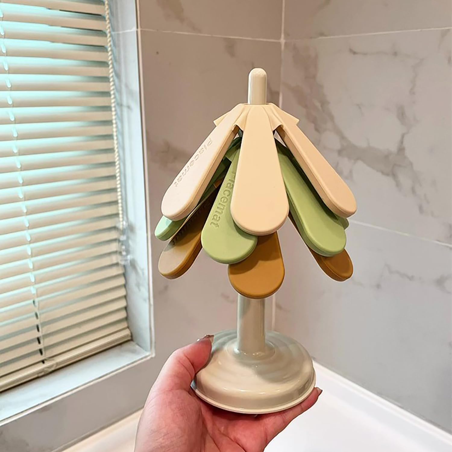 Tree-shaped silicone trivet set with stand in a modern kitchen setting

