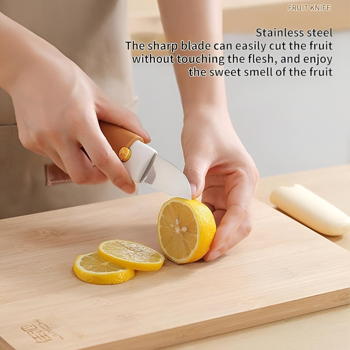 Person slicing a lemon with a knife on a wooden cutting board, with text describing the knife's features.