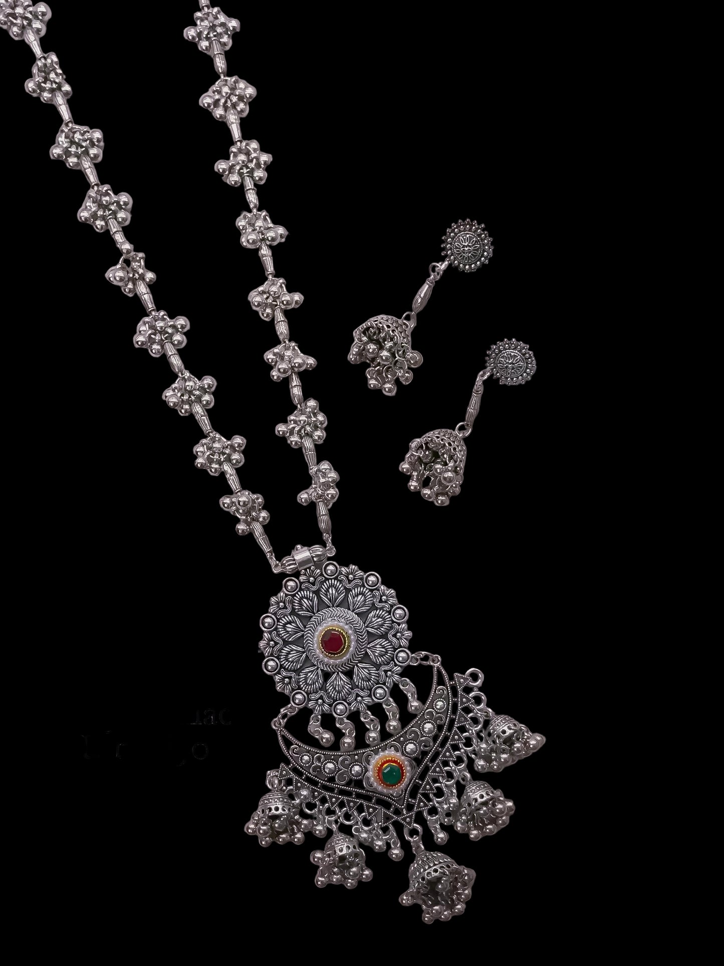 German silver long necklace with floral designs on a light gray background