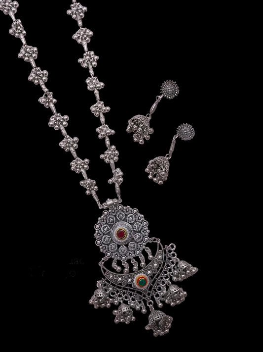 German silver long necklace with floral designs on a light gray background